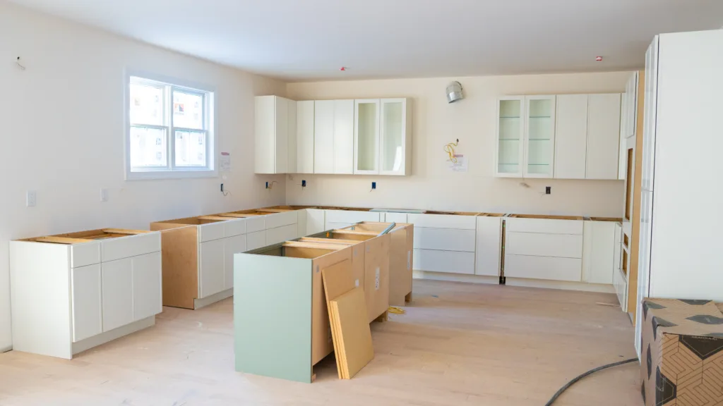 Wide view of the uncompleted Custom Kitchen Cabinets NY showing wall and base units.